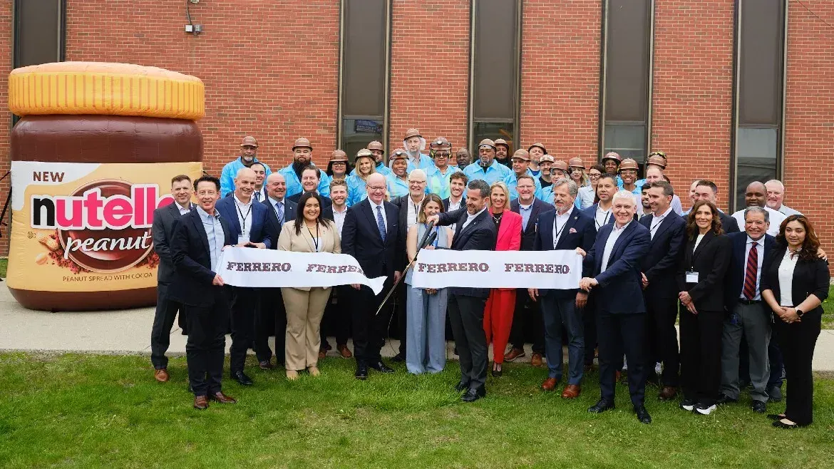 Image shows Ferrero management and employees cutting the ribbon on its new facotry in the US.