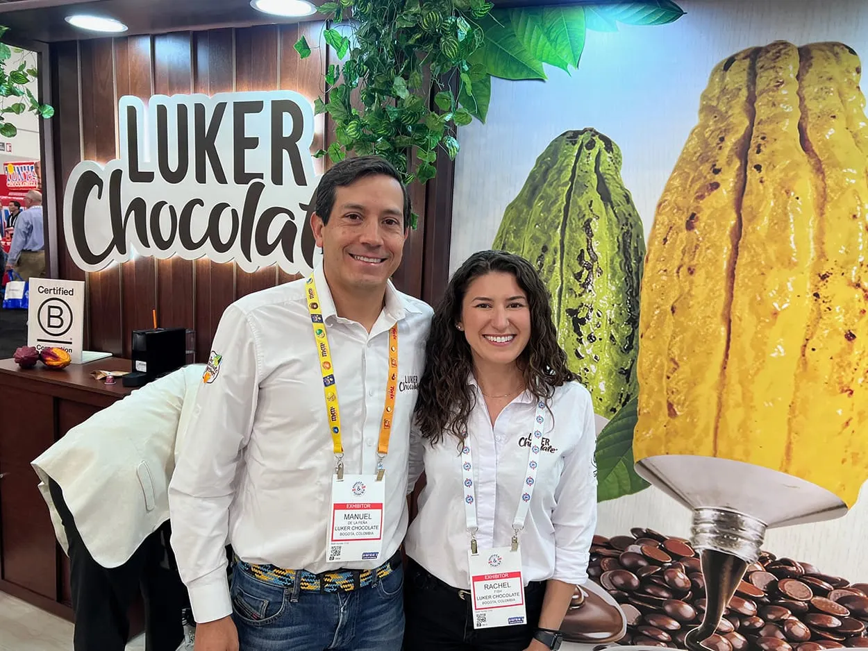 Image shows Rachel Fish and Manuel de la Peña head at the Luker booth at Sweets & Snacks Expo 2026. 