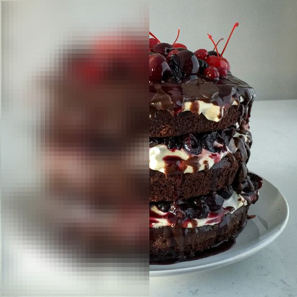 A photo of a delicious black forest cake. Half of the image is blurred.