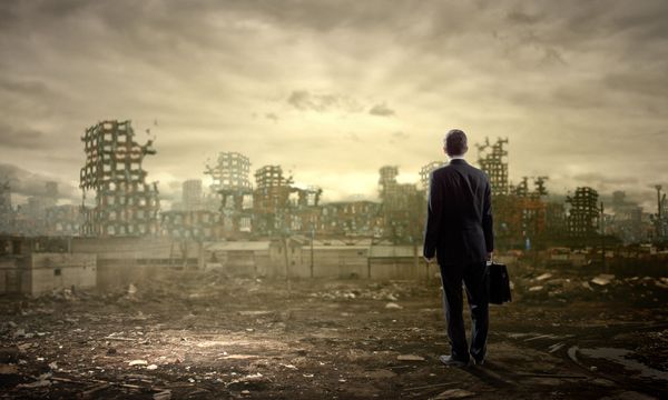 illustration of catastrophic thinking with man with briefcase standing in front of ruined city