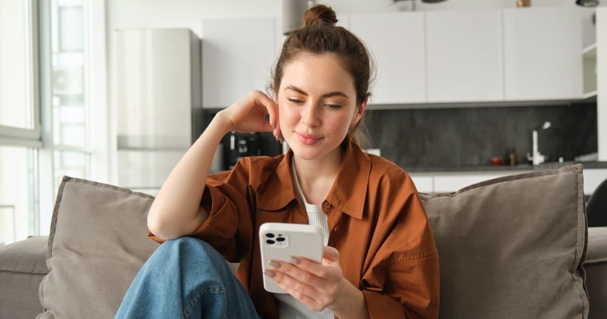 A picture of a young woman admiring her bill. 