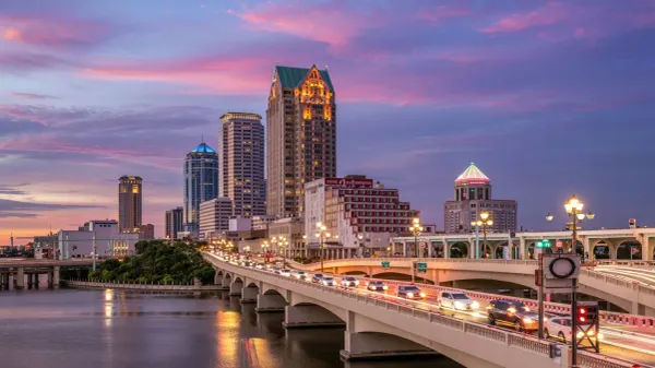 A vibrant skyline of downtown Tampa with cell tower signals overlaid, symbolizing seamless connectivity across the city's diverse landscape.