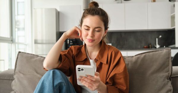 A picture of a young woman admiring her bill. 