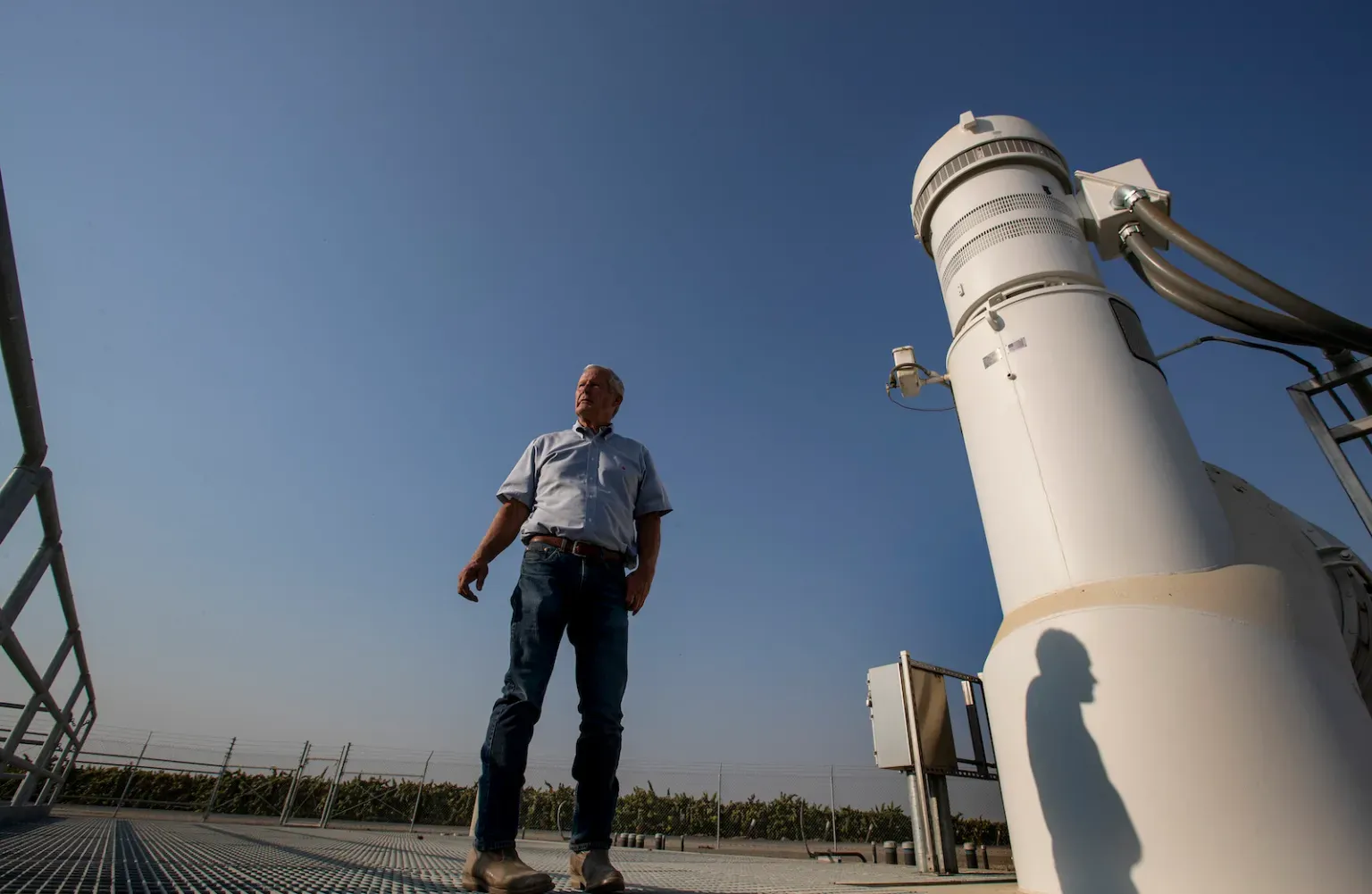 A person standing outdoors surrounded by technical equipment