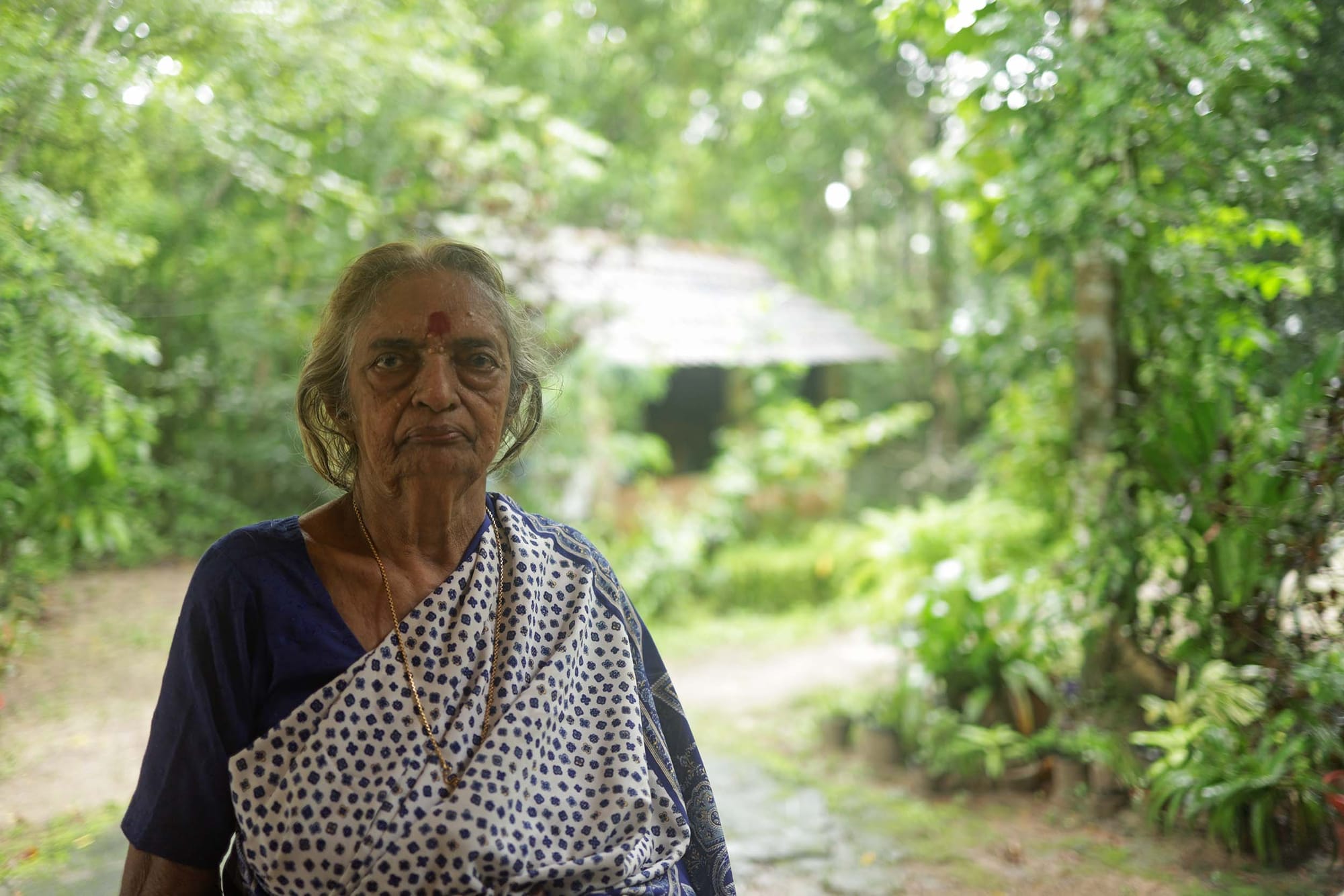 A person posing for the camera in an outdoor environment