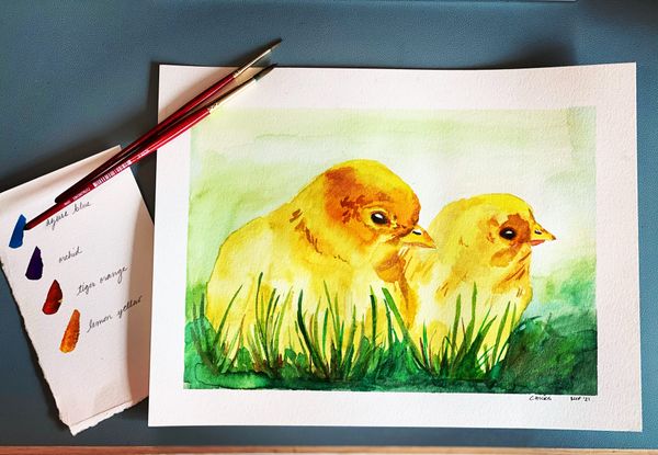 watercolor painting of chicks in grass with paintbrushes and paint swatch