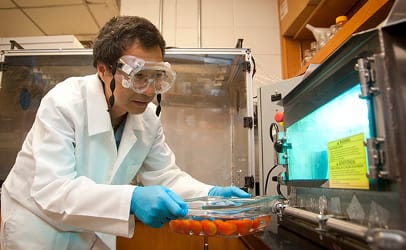 Dr. Haiqiang Chen with his UV light oven in the lab at the University of Delaware. (Photo by Wenbo Fan)