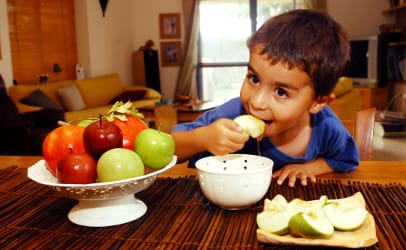 Jewish boy eating holiday apples and honey