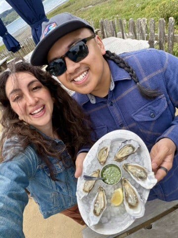 Geronimo and Soraya holding a plate of Hog Island oysters