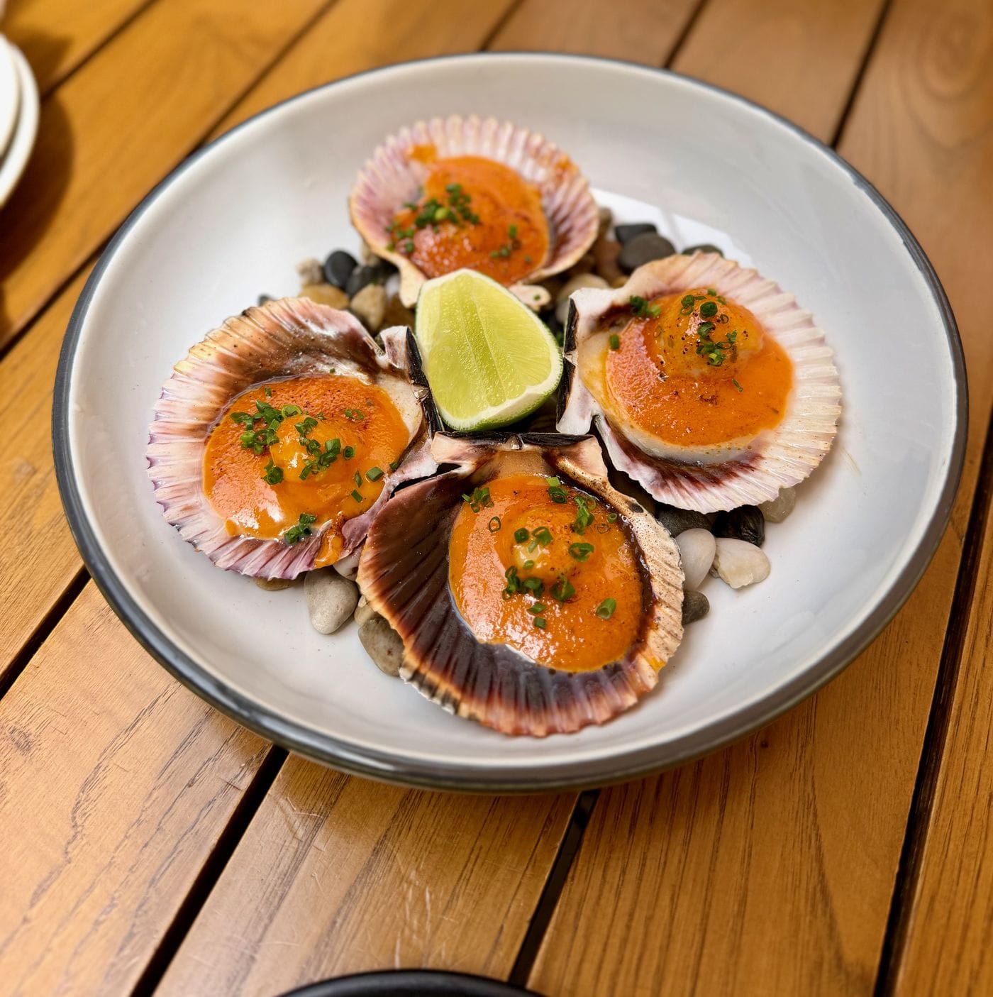 Scallops on the half shell with dynamite sauce and lime at Secret Bao in Santa Barbara