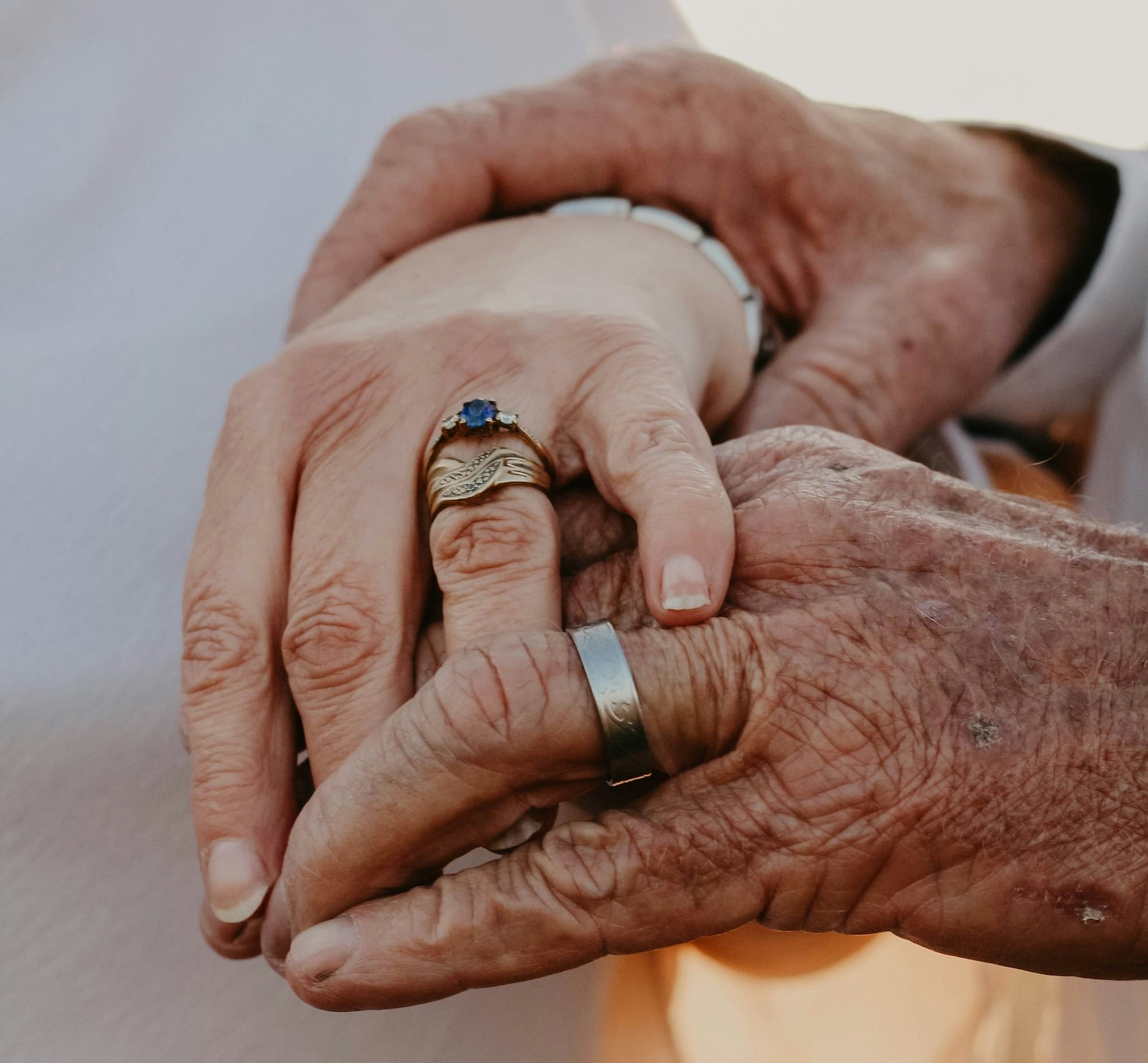 a close up of two people holding hands