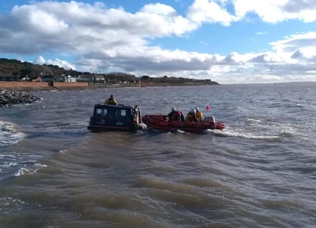 RNLI crew dash from wreath laying to carry out rescue