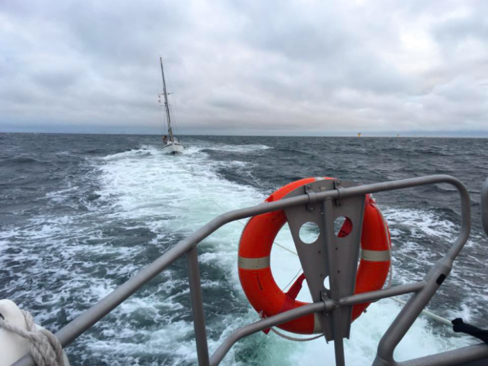 Stricken boat being towed by lifeboat