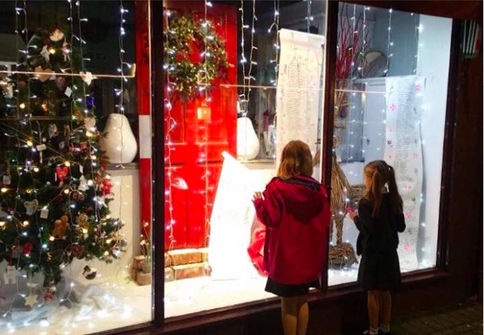 Children looking at Santa's list at Eden Floral Design in West Kirby