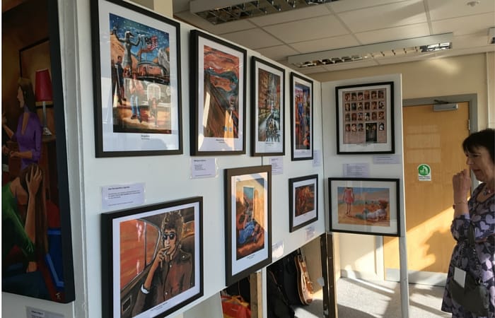 Visitor enjoys last night's preview of Tony Kenwright's "Visions of Bob Dylan" exhibition