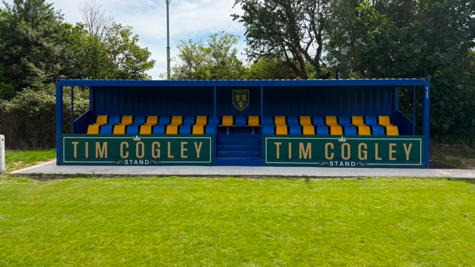 Heswall FC stand at their home ground.