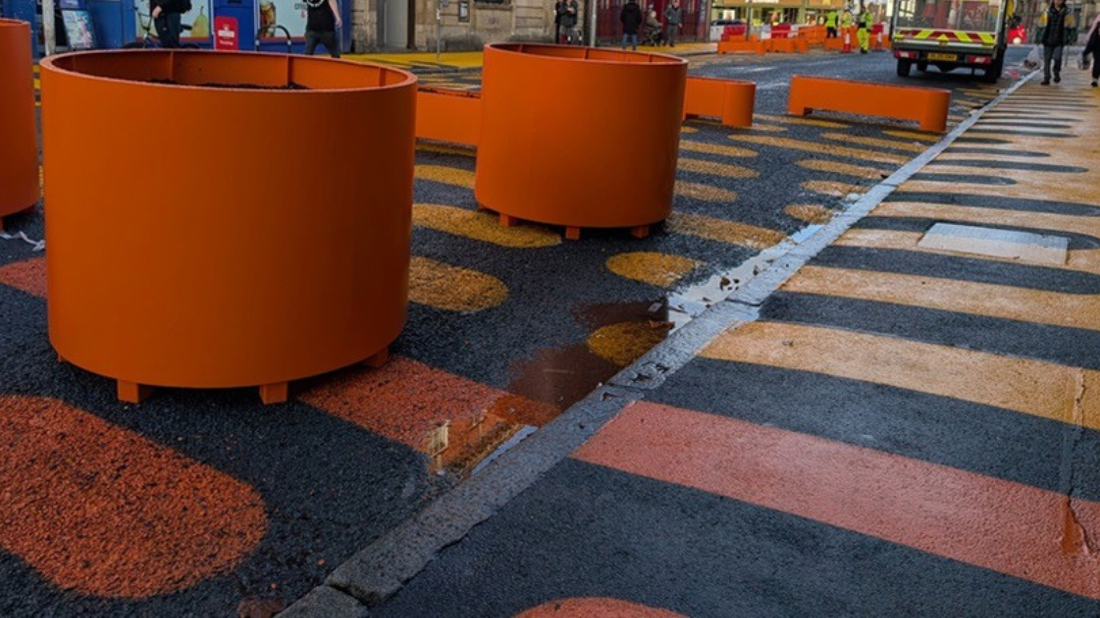 Photo of the orange markings and planters on Grange Road West by the council.