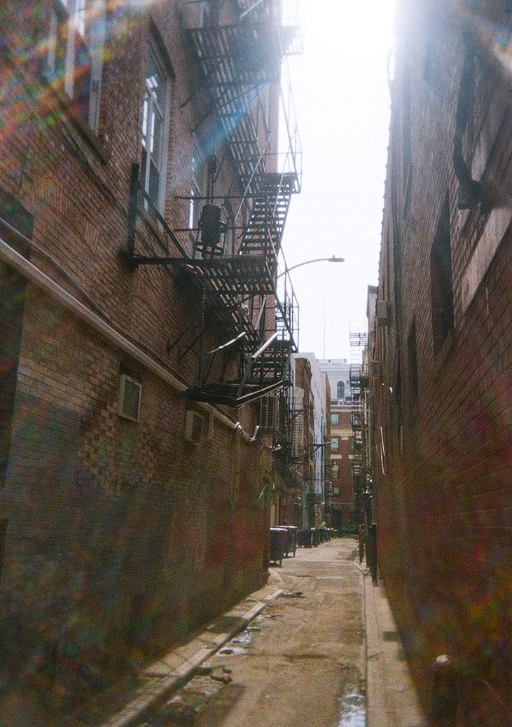 a color photo of an alleyway in Philadelphia, with garbled plastic lens-flare everywhere