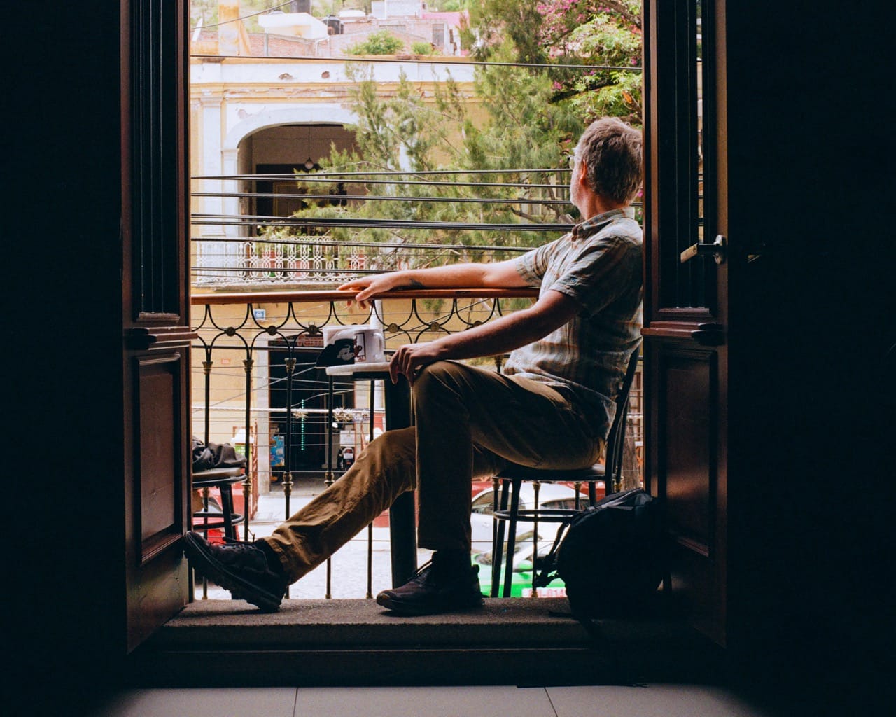 a photo of me sitting in the window of a cafe, looking out at Guanajuato in the background