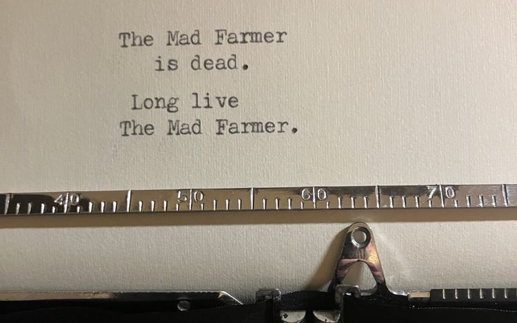 a close-up of a short typewritten poem that reads: 'The Mad Farmer/is dead./Long live/The Mad Farmer.