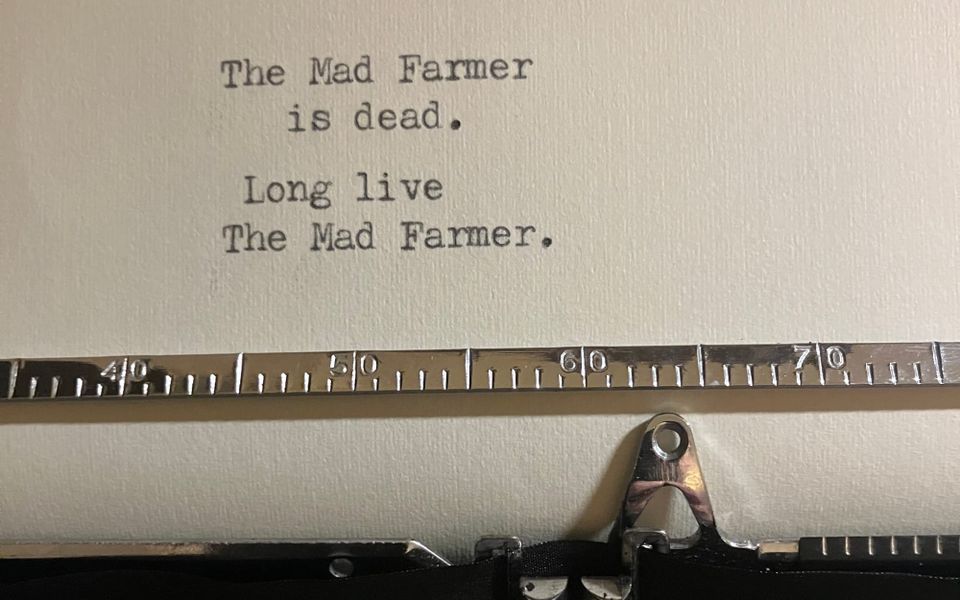a close-up of a short typewritten poem that reads: 'The Mad Farmer/is dead./Long live/The Mad Farmer.