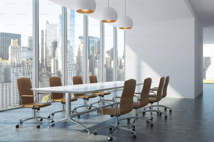 Executive boardroom with an empty seat, representing ICT procurement being excluded from strategic decision-making
