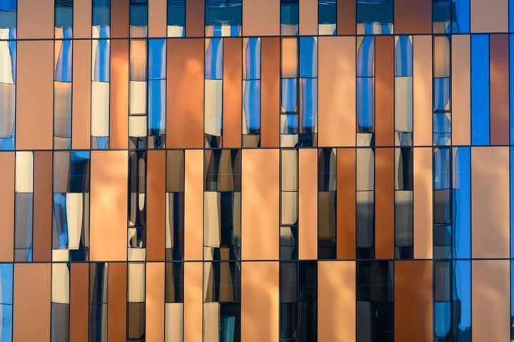 Abstract geometric facade in blue and bronze tones, representing structured controls and enterprise AI spend governance