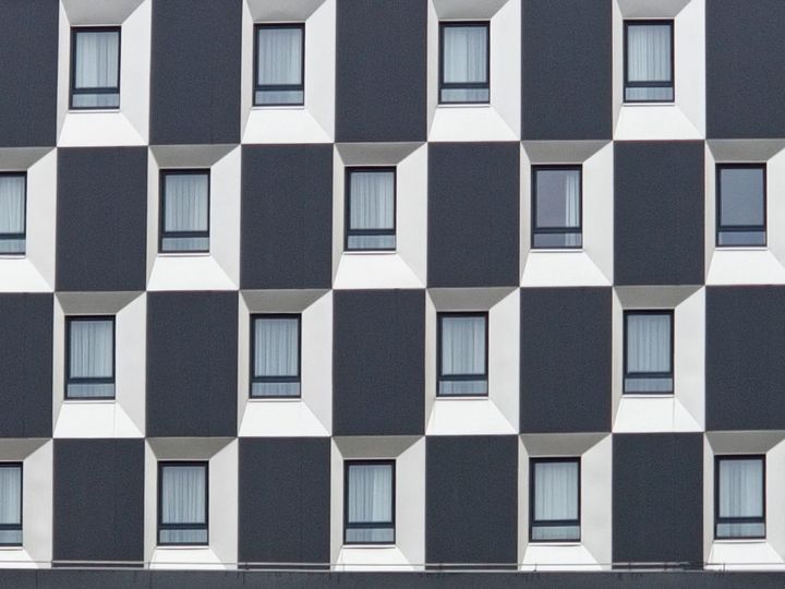 Structured building facade with repeating layers and patterns, representing the layered architecture of enterprise AI models, platforms, and agent technologies.