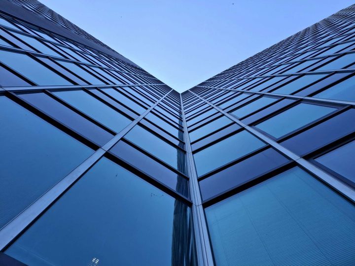 Modern glass office towers viewed from below, representing enterprise technology infrastructure and long-term ICT investment decisions