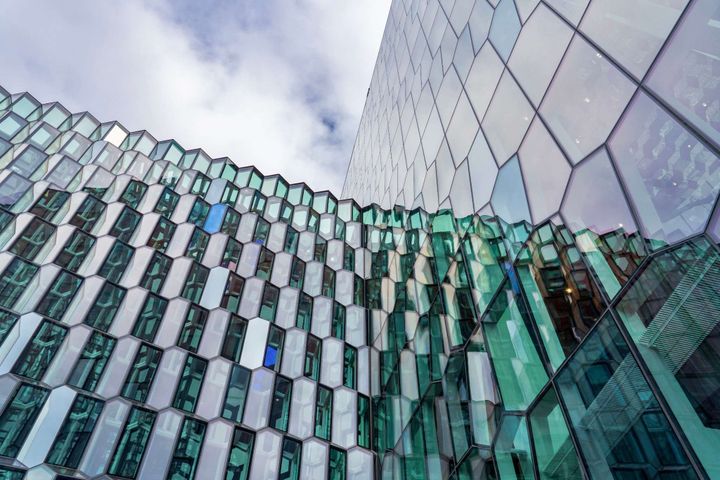 Modern glass office buildings with interconnected geometric architecture representing enterprise ICT strategy and platform interdependencies