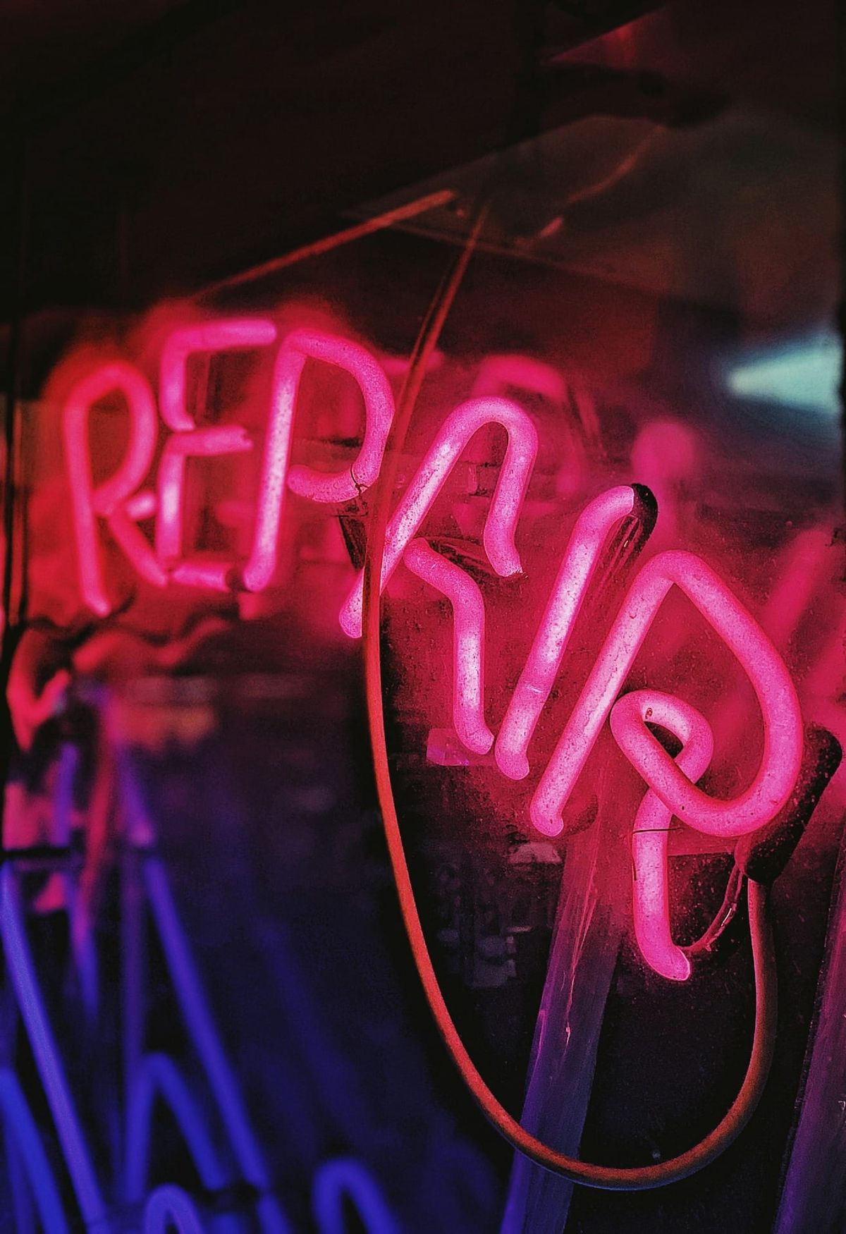 a neon sign that says repair