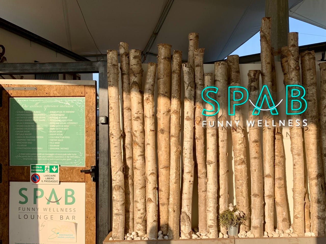 A neon sign reads "SPAB Funny Wellness" next to the spa entrace.