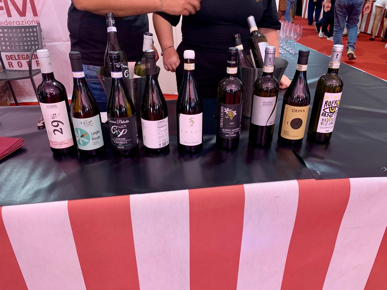 A selection of wine bottles on a table with a red-and-white striped cover