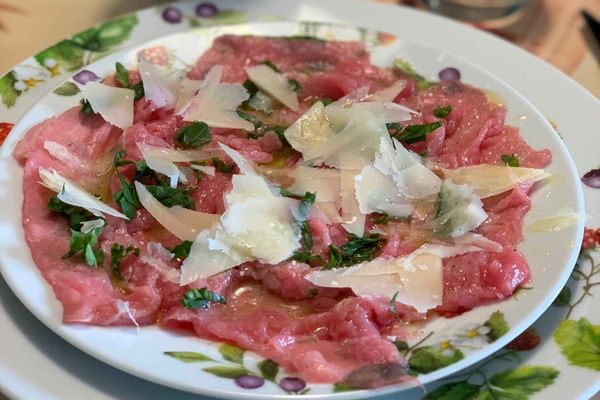 Carne cruda all'albese: thinly sliced veal topped with parmesan, rocket, and olive oil