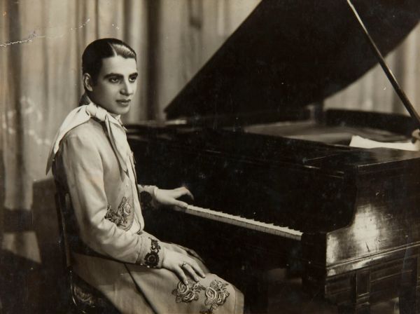 Tango musician Lucio Demare by his piano