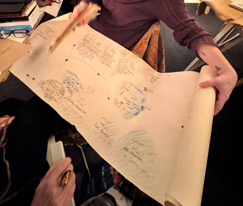 Lorna Rose sharing her Deer counter map on a scroll of paper