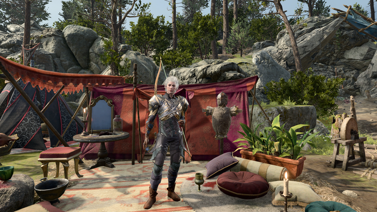 Screenshot from Baldur's Gate 3. Astarion in his armor, standing in front of his tent in the camp in the Emerald Grove environs.