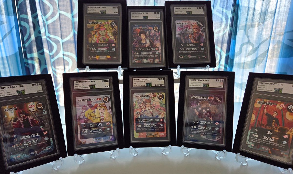 Eight signed trading cards in slabs displayed on stands.