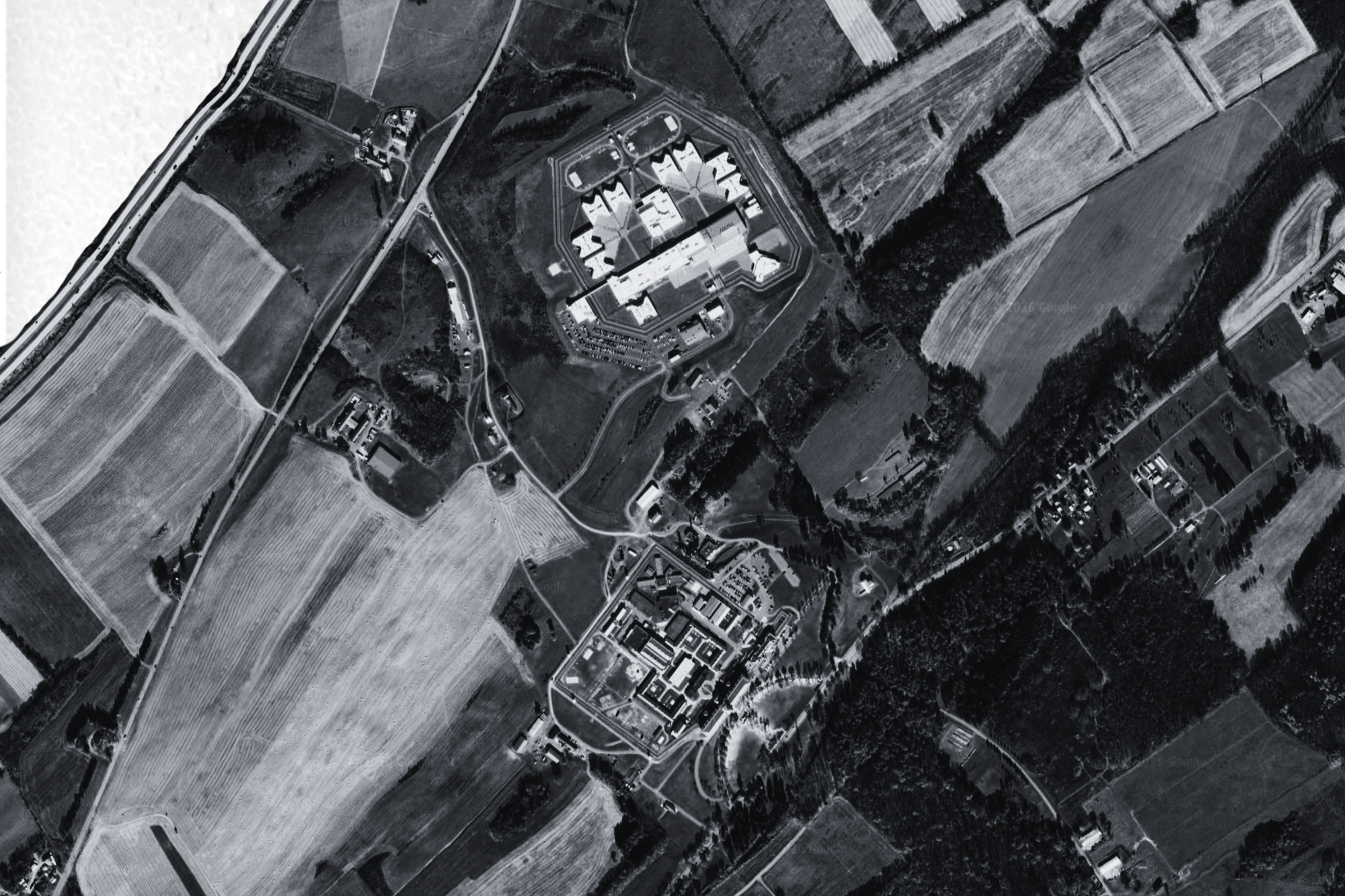 Two prisons next to farmland.