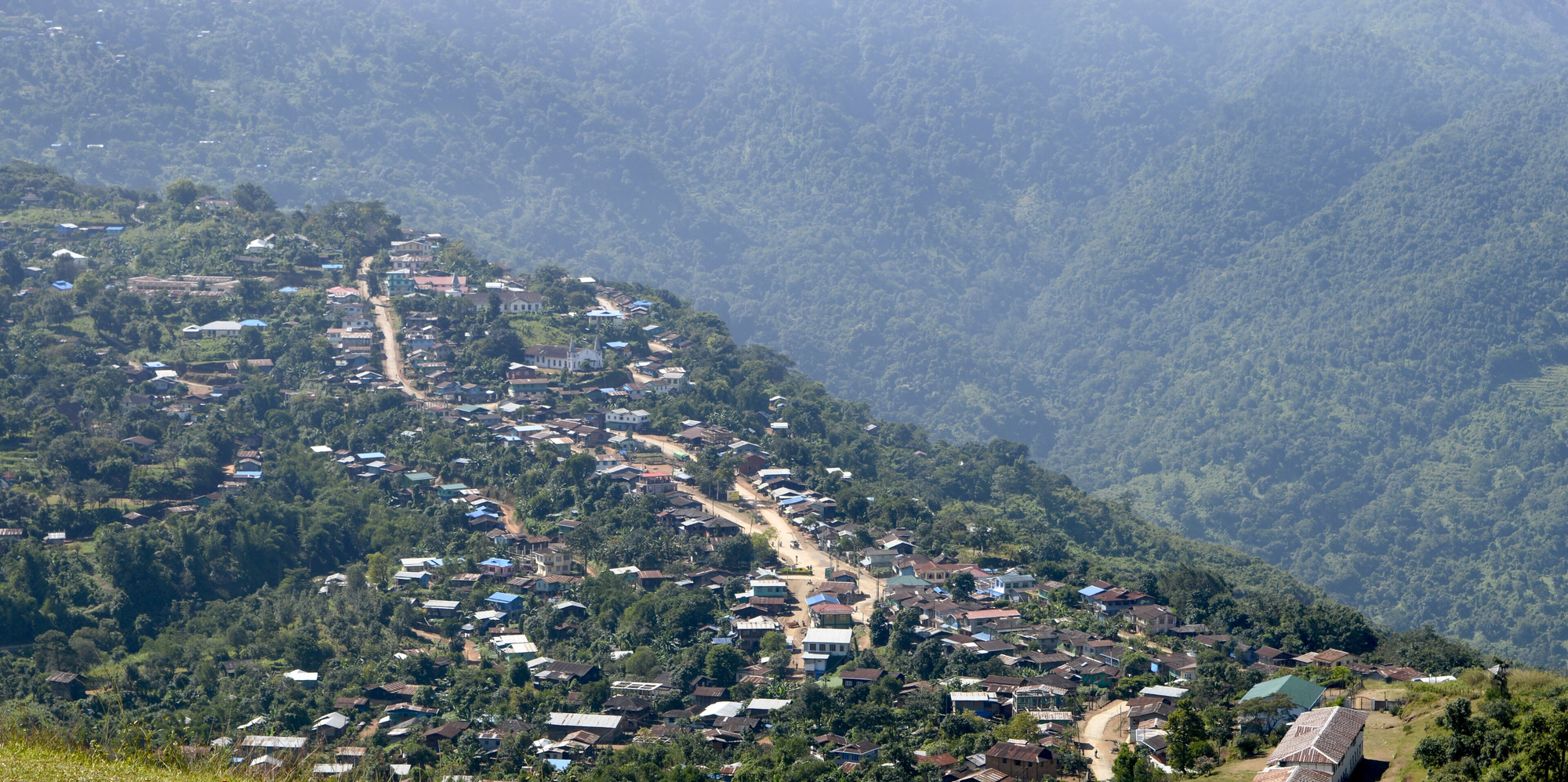 Houses along a lush mountain ridge