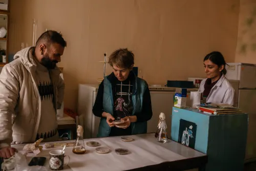 Galeb Al-Maali, Margarita Lomberg and Alisa Atamanchuk work with fungal strain samples in a laboratory.