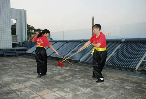 Hon-Ming Lam and his daughter practice martial arts together on an open rooftop.