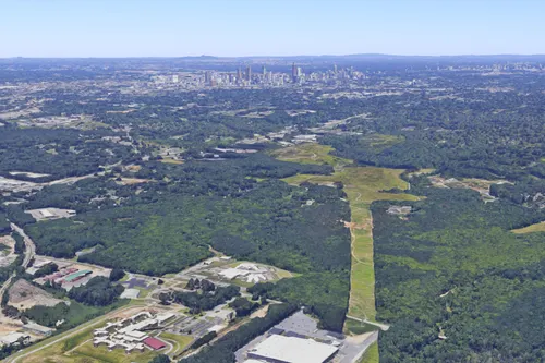 Bird's-eye view of the "Cop City" site and residential neighborhoods looking northwest, with the Atlanta skyline in the background