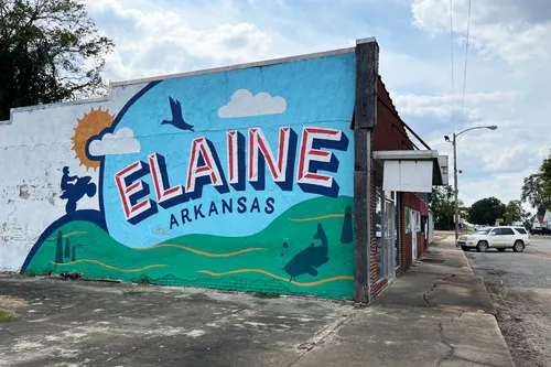 A mural on the side of a store with the words "ELAINE, ARKANSAS