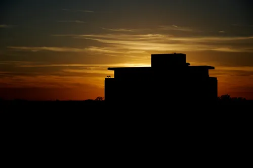 A silhouette of Dale Hall Tower against the evening sky at dusk