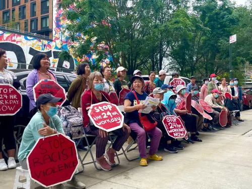 Home care workers protest outside the Chinese-American Planning Council building.