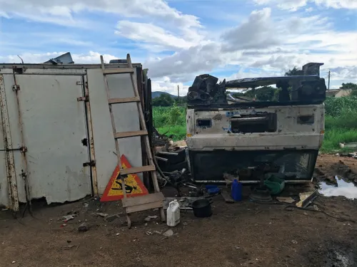 A car flipped upside down in an auto junkyard