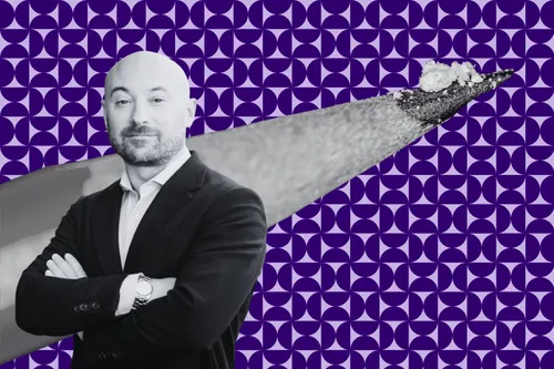 Prof. Marco Pravetoni, a white man in a suit, crosses his arms. Behind him is a pencil tip with enough fentanyl in white powdered form to kill a person.