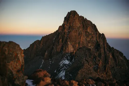 A view of a snowy peak at dawn.