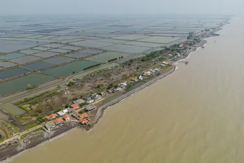 Aerial view of a village on the water's edge.